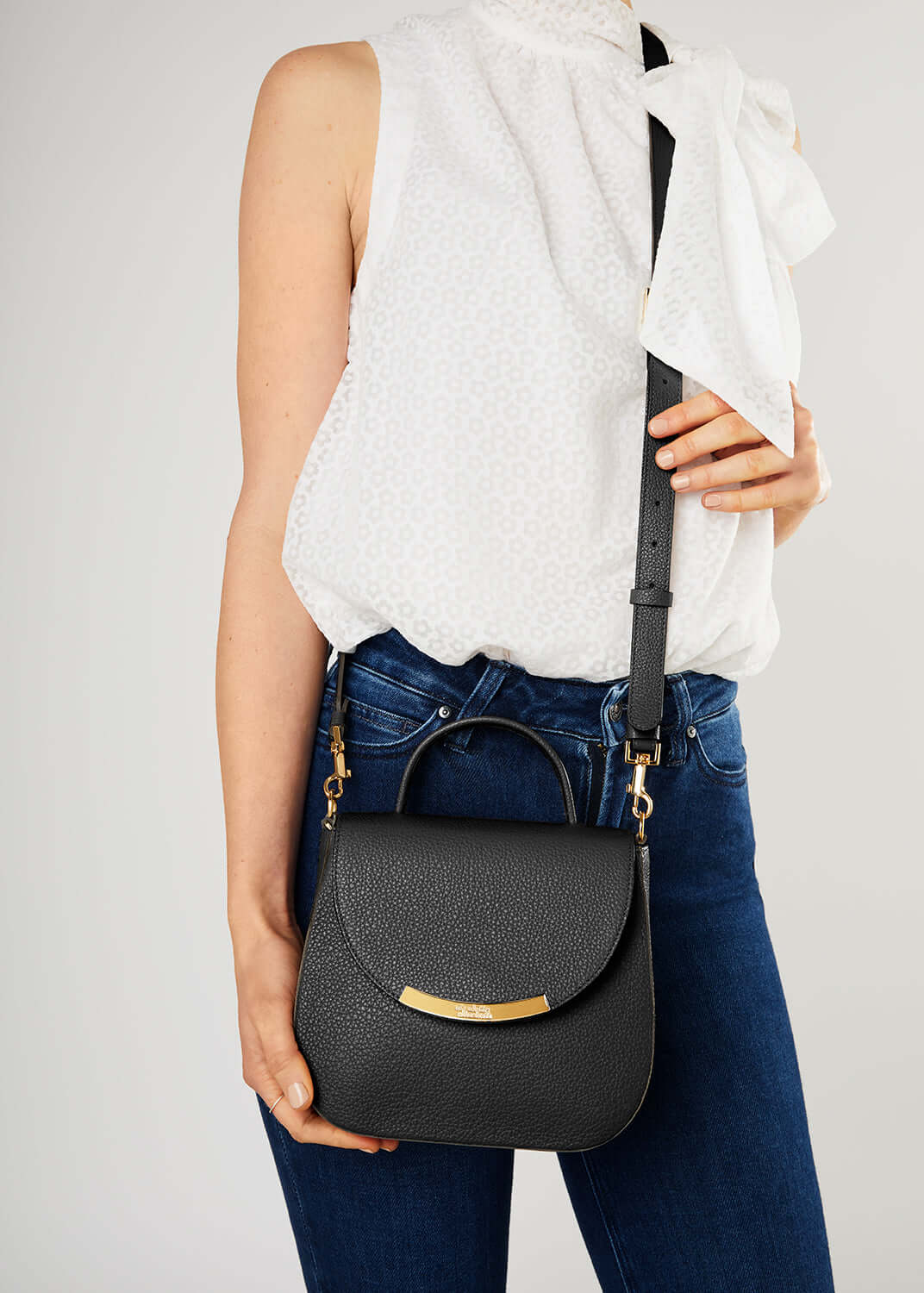 ladies leather handbag in black, miniature sized crossbody strap